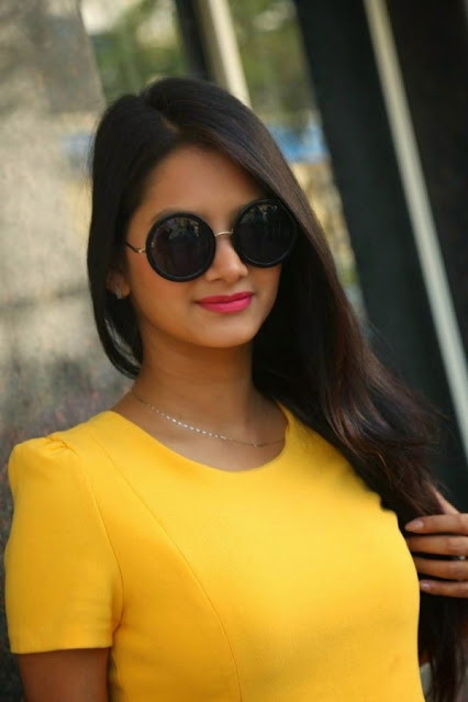 Mounika Singh looking radiant in a yellow dress, embodying Telugu elegance and joy.