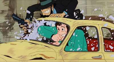 movie Lupin the Third: The Castle of Cagliostro - Lupin and Jigen in a car chase - they clear the shattered car window