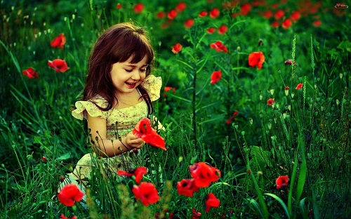 Beautiful Baby Girl Playing with Flowers 