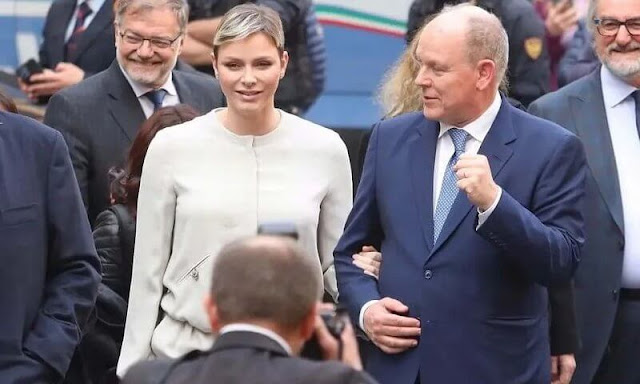 Princess Charlene wore crew-neck jacket and trousers by Emporio Armani, and tulle and sequin long sleeve a-line gown by Akris