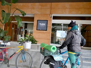 Entrance of a for star hotel, Aim'jie and our 2 bikes in front.