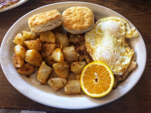 schnitzel with poached eggs, German potatoes, and biscuits