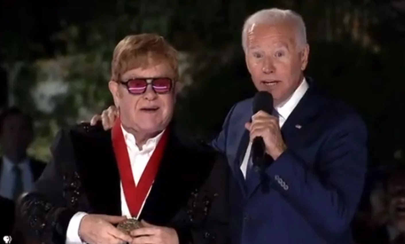 WOW! Joe Biden Wraps His Arm Around Elton John, Then Tells Crowd, “It’s All His Fault We’re Spending $6 Billion on HIV and AIDS this Month” (VIDEO)