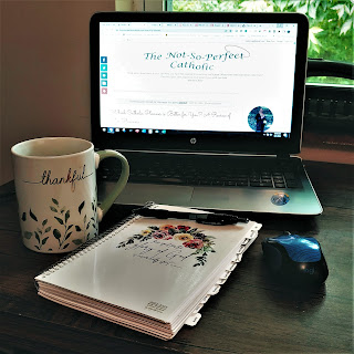laptop open to blog page with planner, and coffee cup