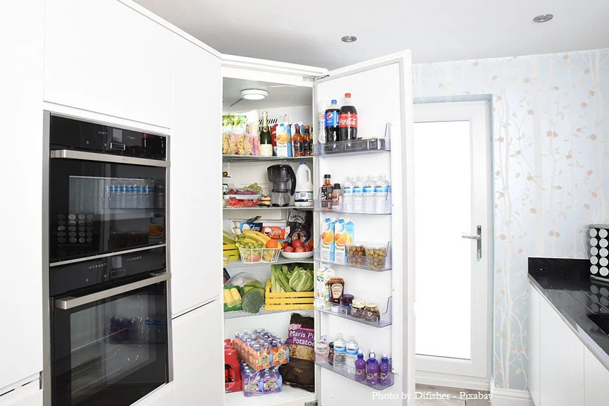 large fridge with door ope full of food