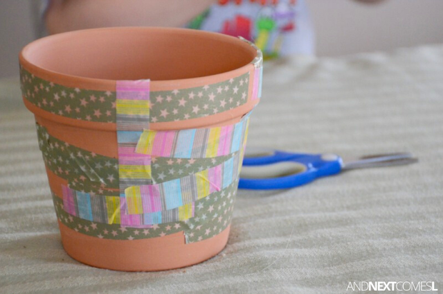 Small flower pot decorated by a child using washi tape