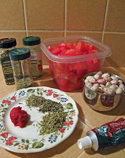 Chopped tomatoes, measured beans, and measured tomato paste and herbs