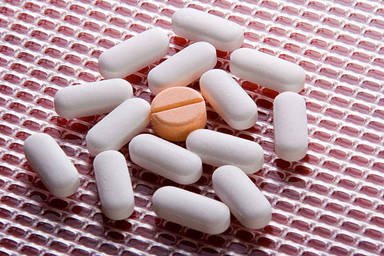 white-pills-with-an-orange-on-in-the-center