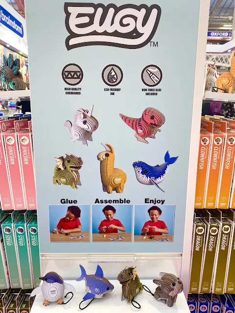 A display area showing assembled Eugy cardboard animals including a penguin, shark, dragon and dog