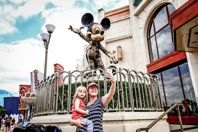 Mickey Mouse statue with parent and child