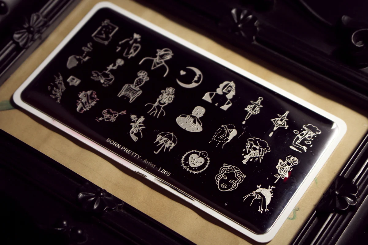 an aesthetic close-up of a stainless steel nail stamping plate with spooky halloween pattern