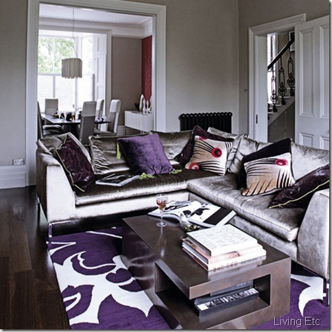 Open plan grey through lounge living room dining room silver sofas decorative purple rug coffee table pendant lamp shades assorted cushions real home L etc 09/2007 pub orig 