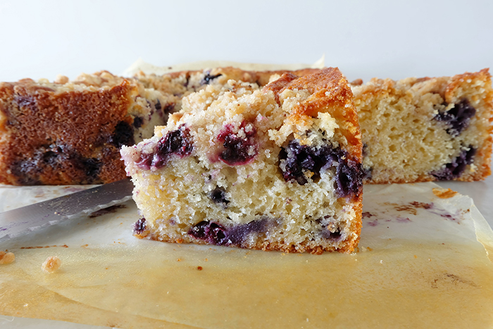 side view of slice of streuseled blueberry coffee cake