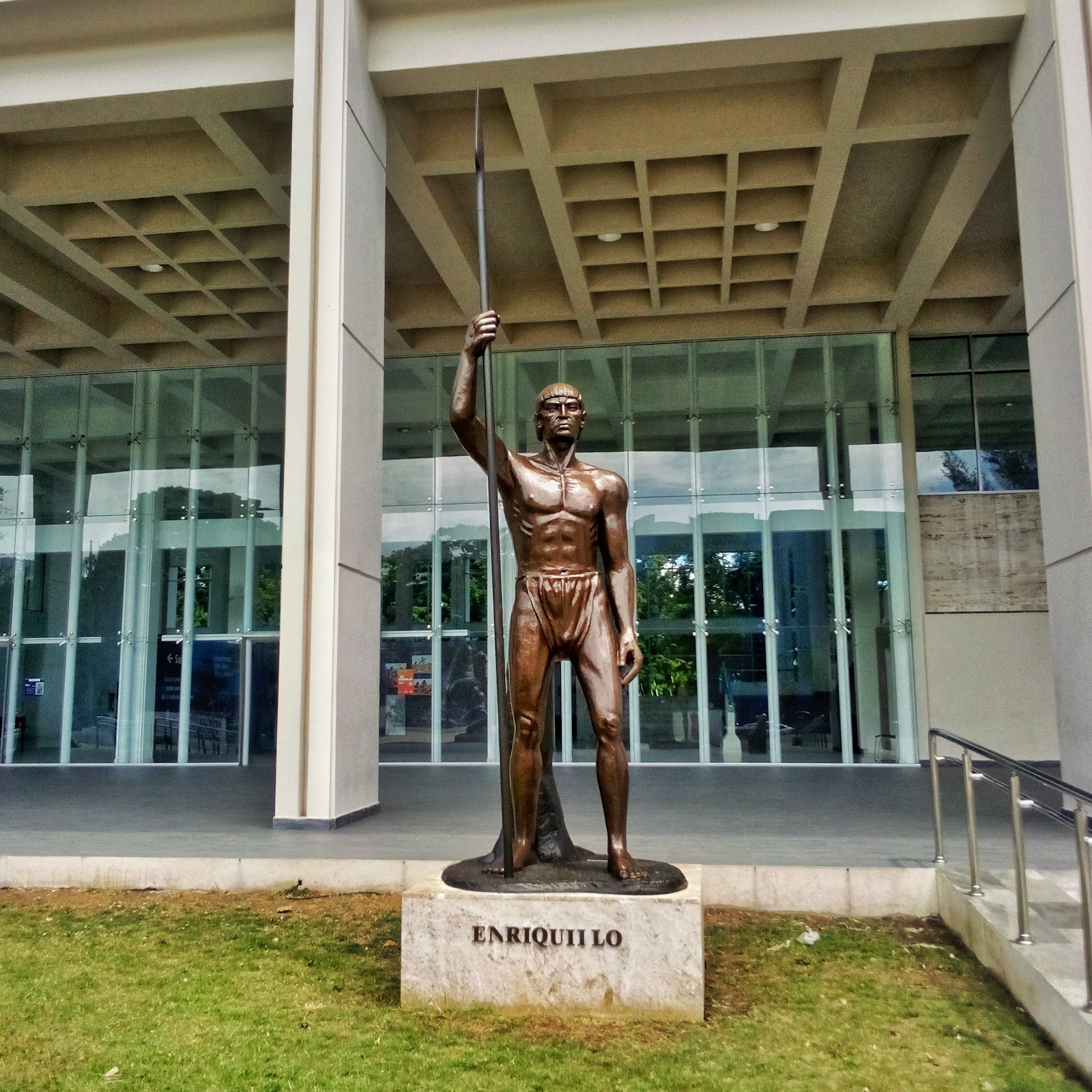 Statue of Enriquillo Statue of Enriquillo; a muscular young man wears a loincloth and holds a long spear.