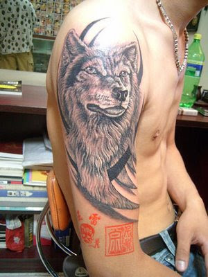 A wolf tattoo on the arm.