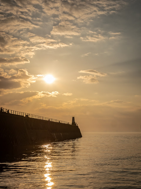 Photo of Maryport pier with the sun low in the sky