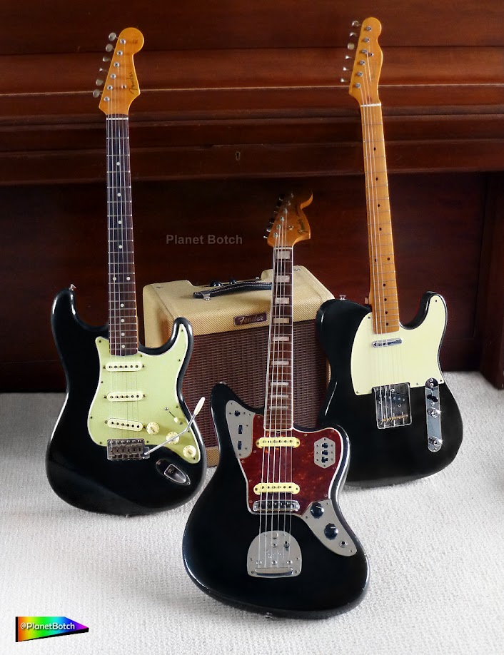 Black vintage type Fender guitars - Stratocaster, Jaguar and Telecaster - on white carpet, in front of a piano and Pro Junior tweed amplifier.