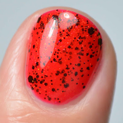 red nail polish with black glitter close up