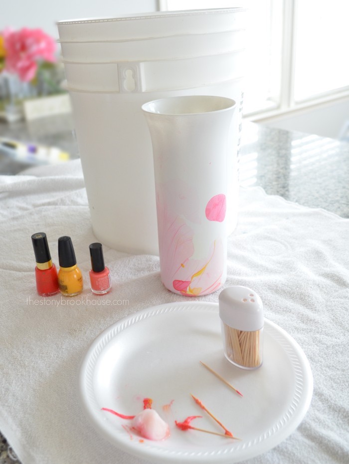 Nail polish, bucket and toothpicks for marbling