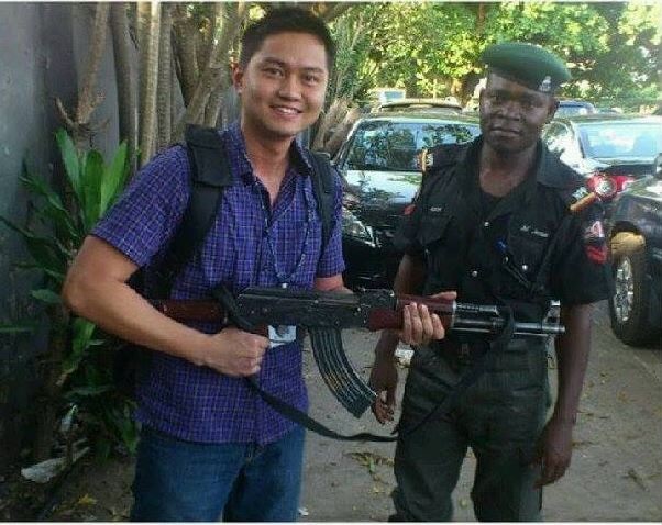 Ignoramus: Nigerian Policeman Lends His Gun to an Asian Man for Picture Pose (Photo)