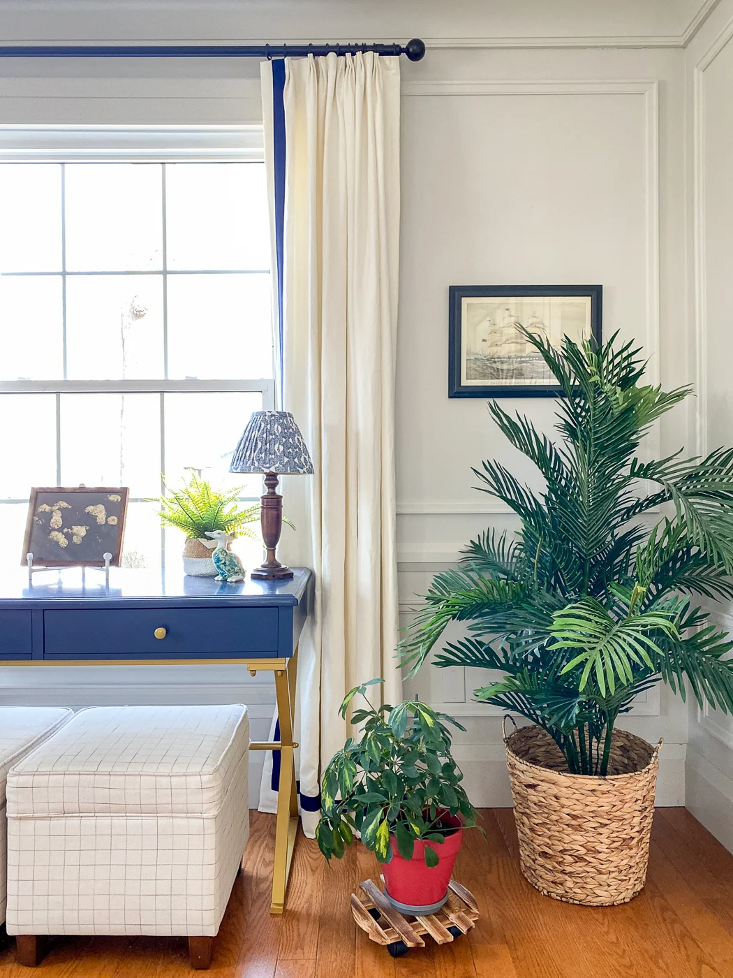 long living room with window treatments and moulding