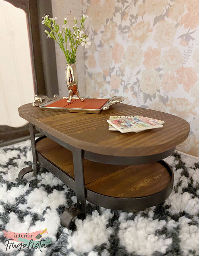 How to repurpose a bathroom metal soap and lotion dispenser caddy into an adorable rustic industrial-style dollhouse coffee table with wood slat top.