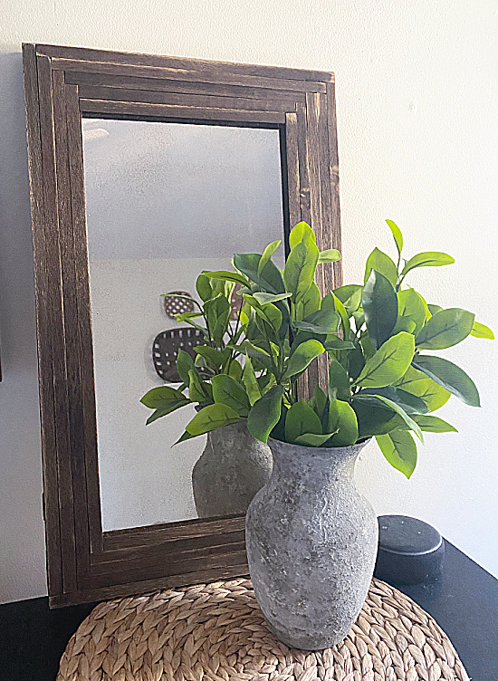 rustic frame with cement planter and greens