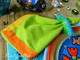 Tropical fish tablescape, Department 56 Mirage plates, tropical fish glasware.