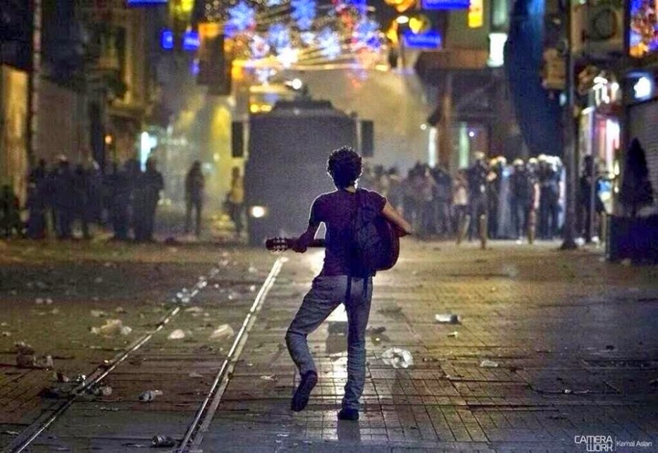 35 moments of violence that brought out incredible human compassion - a turkish protestor plays guitar for police