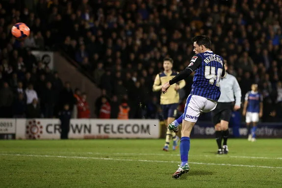 Rochdale player Ian Henderson shoots to score his team's second goal against Leeds