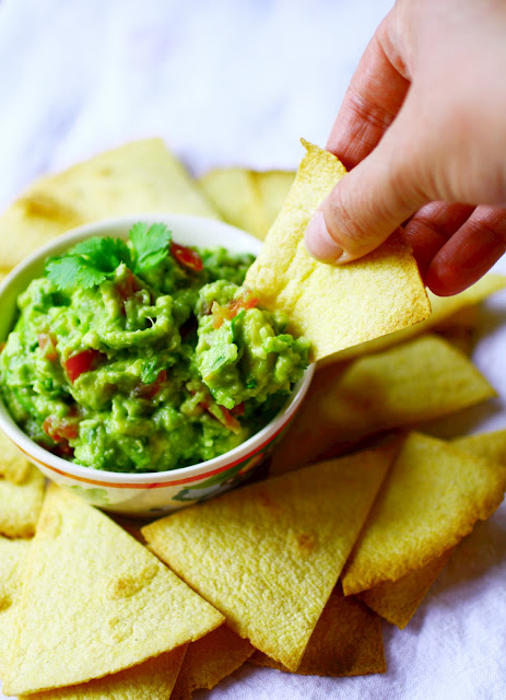 My go-to recipe for fresh, homemade guacamole.  A simple mix of avocado, spring onion, coriander/cilantro, tomato and lime - perfect for dunking chips in, topping a burger with or as a side for brunch.