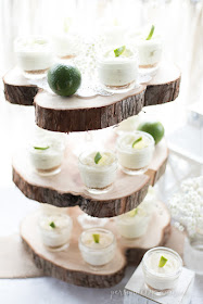 Rustic and romantic spring bridal shower | Three tiered wood slice serving piece with mini individual lime cheesecakes in mason jars | personallyandrea.com