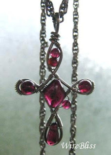 wire wrapped cross with garnet