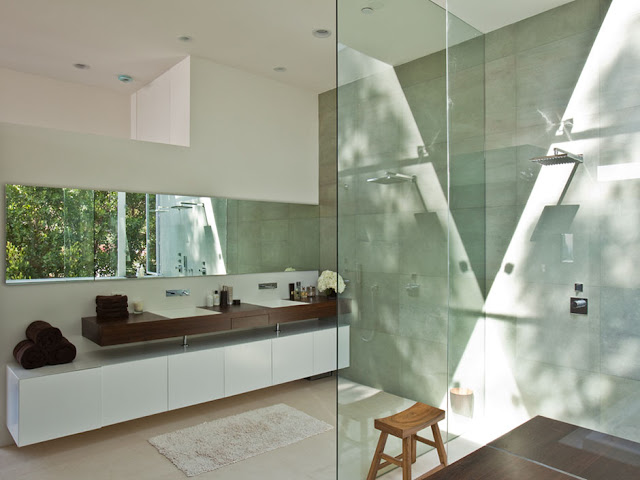 Picture of the beautiful modern bathroom with large shower cabin and large mirror on the wall