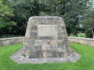 A close-up photo of the stone monument to the Battle of Roslin.  There is a plaque on it that reads - Battle of Roslin 24th February 1303.  Photo by Kevin Nosferatu for the Skulferatu Project.