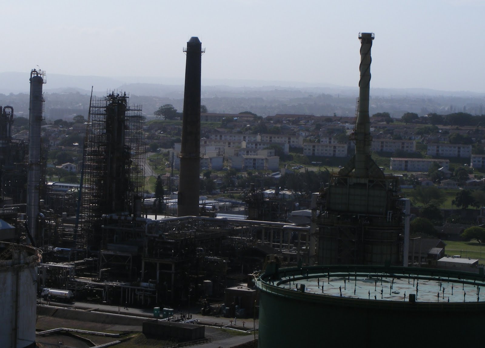 ... plea; the Engen oil refinery with houses in the background