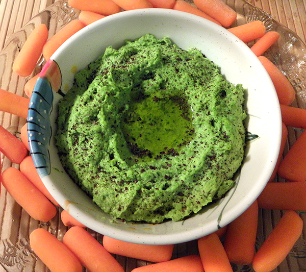 Green Pea Hummus Bowl Surrounded by Carrots