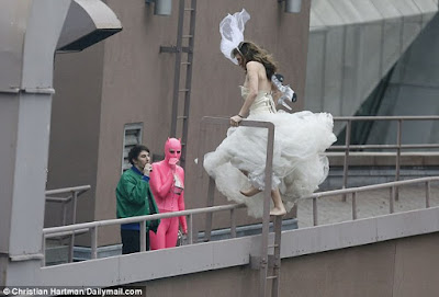 Bride, Her Wedding Gown And Her Unlikely Partner Seen Climbing Up A Rooftop In New York. 3