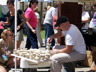 Potter craftsman and his wares with a customer