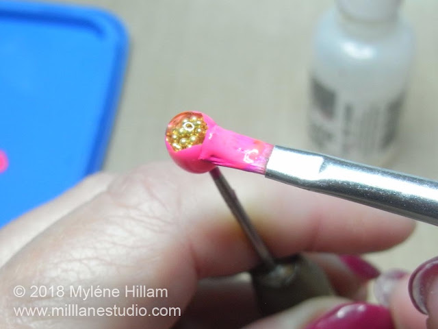 Using the paint brush to paint a second layer of darker pink petals in between the gaps in the first layer of petals.