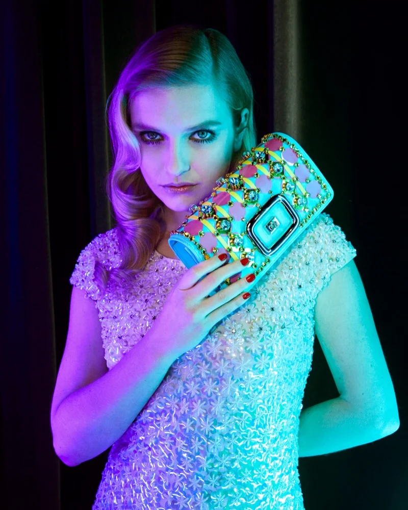 Actress Camille Razat poses with Roger Vivier Viv’ Choc bag