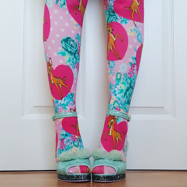 front of legs in colourful printed Bambi tights with mint green sandals with fluffy ears