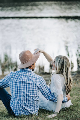 couple holding hands by the lake