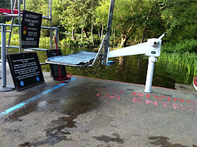 picture of a flatbed hoist on the deck in front of the water. Just to the left is the lifeguard tower.