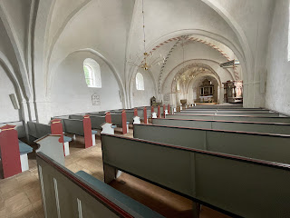 Tved Kirke inside showing walls and ceiling painted white when church switched from Catholic to Protestant
