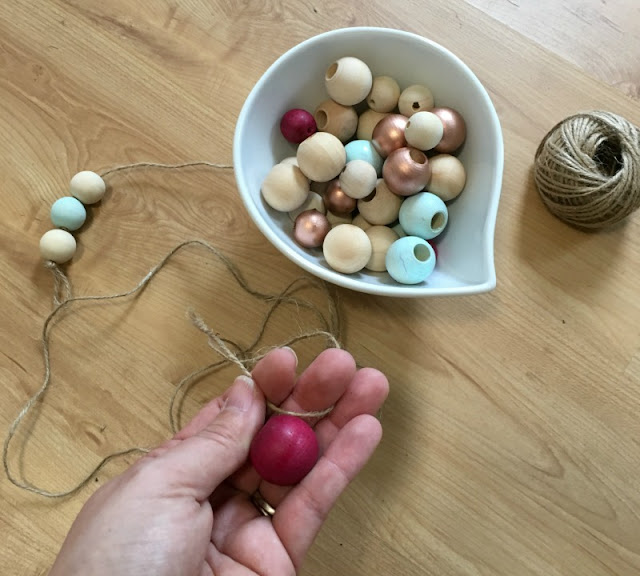 Make a colorful wooden bead garland that you could use as a necklace or home decor!