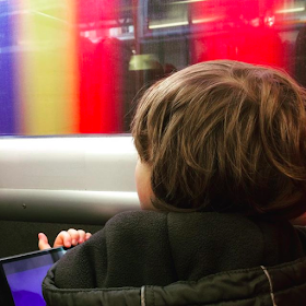 Boy with autism on a colourful train