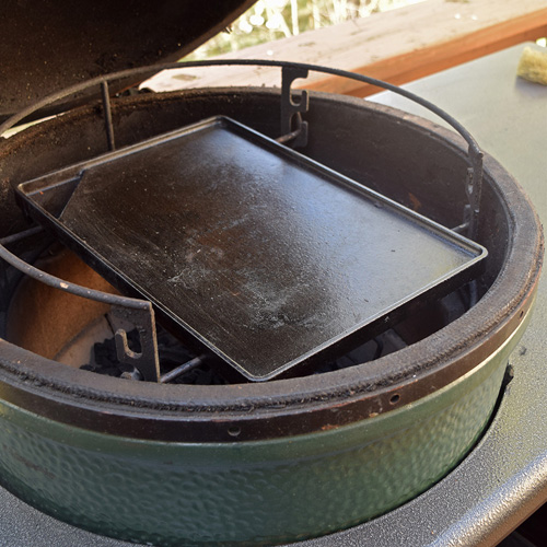 Griddle set up for making smashburgers on a big green egg kamado grill