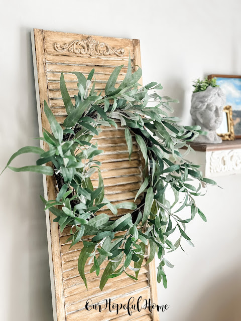 eucalyptus leaf wreath hanging on vintage shutter