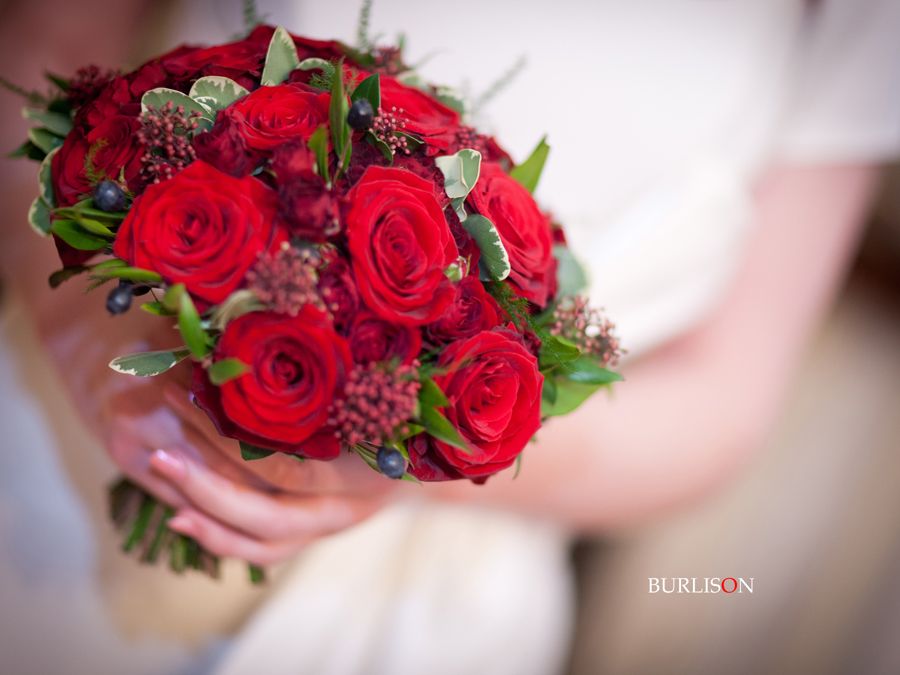 Christmas themed bouquet of red roses skimmia spray roses and mixed 